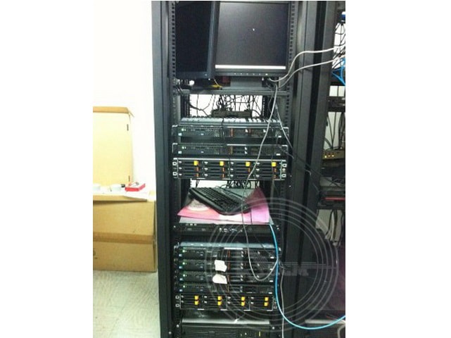 A computer with wires in a server room